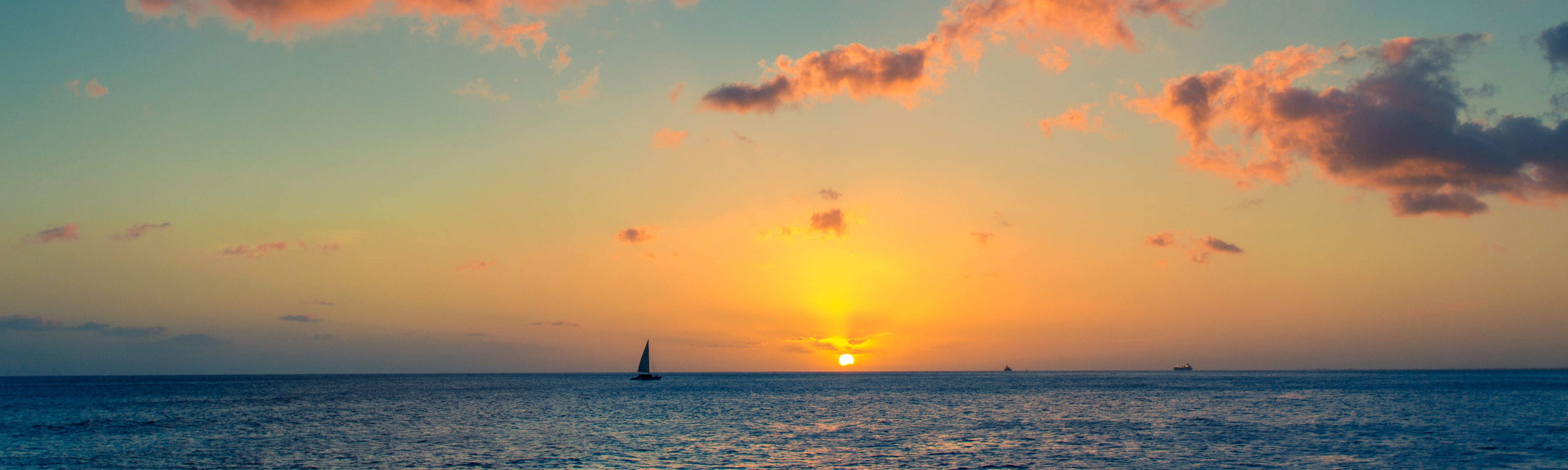 A boat on the water at sunset.